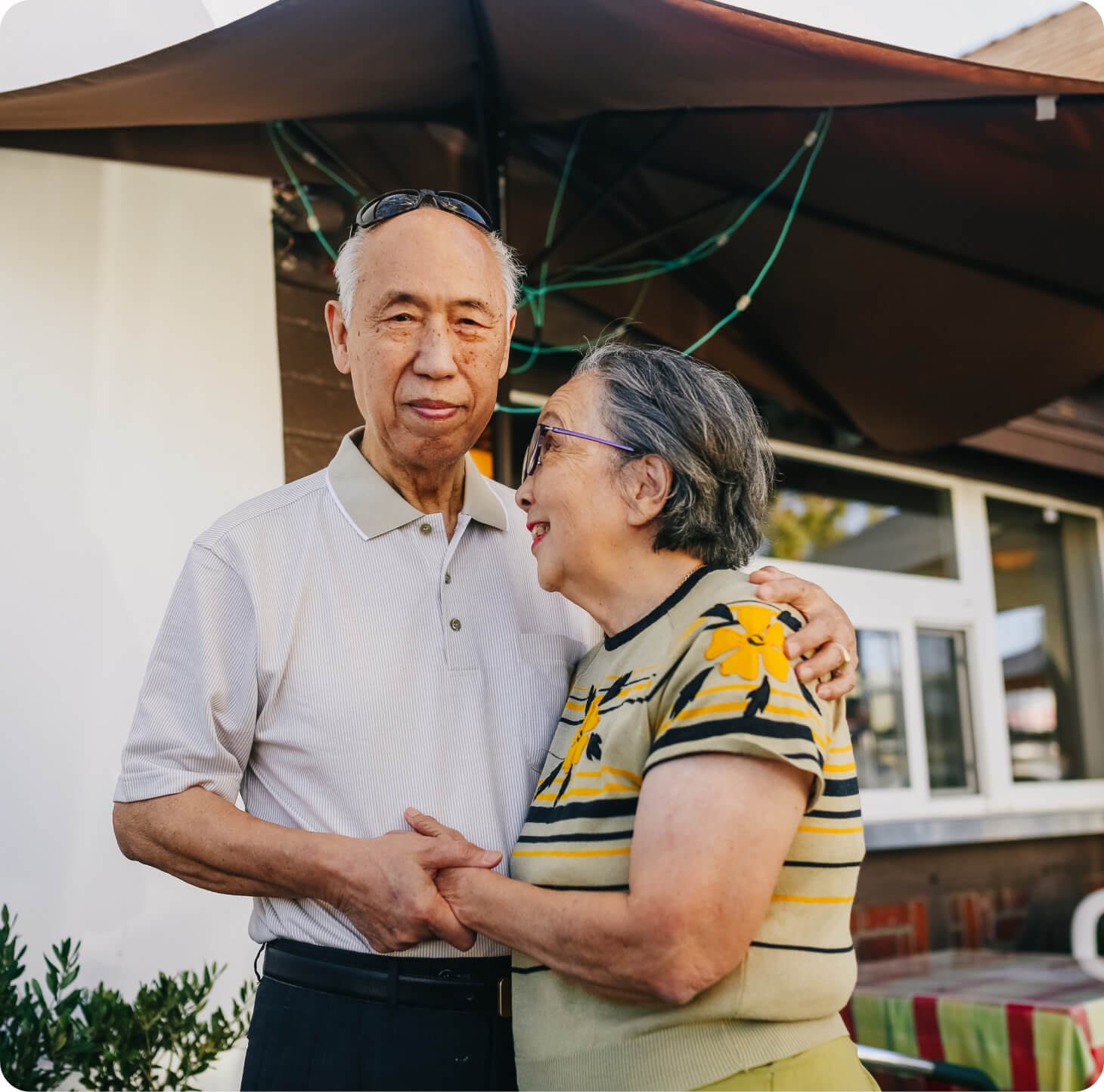 An couple embracing under an umbrella.