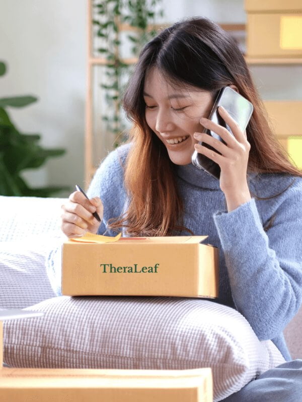 A woman talking with a doctor while sitting on a couch next to a TheraLeaf box.