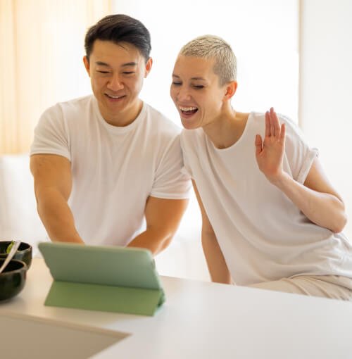 A man and woman are looking at a Theraleaf medical team